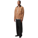 Man wearing a brown jacket and black pants on a white background