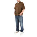 Man wearing a brown shirt and blue jeans on a white background