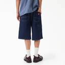 Person wearing blue denim shorts on a white background