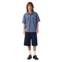 Person wearing a blue striped shirt and navy shorts on a white background