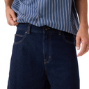 Person wearing a blue striped shirt and dark blue jeans on a white background