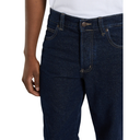Dark blue jeans worn by a person on a white background