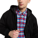 A man wearing a black zip-up hooded jacket over a red, blue, and white plaid button-down shirt, shown from the chest up against a plain white background.