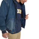 A man wearing a blue denim zip-up jacket over a navy blue t-shirt with 'CKIE' in yellow varsity letters, paired with khaki pants, shown against a plain white background.