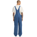 Person wearing blue denim overalls on a white background