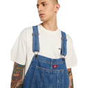 Person wearing blue denim overalls with a white shirt on a white background