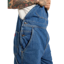 Blue denim coverall worn by a person with tattoos on a white background