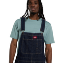 Person wearing blue denim overalls with a visible brand logo on a white background