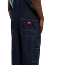 Dark blue denim overalls with a red logo patch on a white background