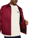 A man wearing a burgundy zip-up jacket over a cream crewneck sweater, with the jacket open to show a black interior lining. The Dickies logo is visible on the chest of the sweater.
