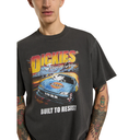Person wearing a black t-shirt with a colorful graphic and text, featuring a car and 'Dickies' branding.