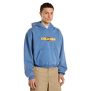 A man wearing a light blue Dickies pullover hoodie with a yellow and black logo on the chest, paired with khaki pants, against a plain white background.