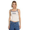 Woman wearing a white tank top with 'Dickies' branding and blue jeans on a white background