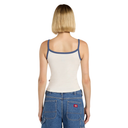 Person wearing a white tank top with blue trim and blue jeans on a white background