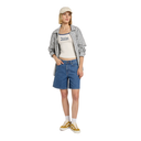 Woman wearing a plaid shirt, white tank top, blue shorts, and yellow sneakers on a white background