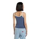 Woman wearing a blue tank top and light blue jeans on a white background