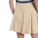 Beige skirt worn by a person on a white background