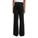 Black wide-leg work pants shown from the back on a model, featuring a small orange and white Dickies logo on the upper right hip.