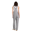 A model viewed from the back wearing gray and white vertically striped work bib overalls over a white tank top, on a solid white background.