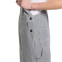 Close-up of a person wearing gray and white vertically striped corduroy overalls with dark buttons, shown against a plain white background.