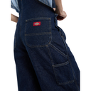 Blue denim work pants with a Dickies logo on the pocket against a white background