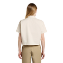 Woman wearing a beige short-sleeve shirt and beige pants on a white background