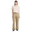 Woman wearing a beige shirt and khaki pants on a white background