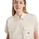 Person wearing a beige short-sleeve shirt with a Dickies logo on a white background