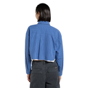 A model shown from the back wearing a cropped blue striped shirt and dark gray pants against a plain white background.