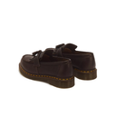 A pair of dark brown leather tassel loafers with yellow stitching and dark brown soles, shown from a rear three-quarter angle on a white background.