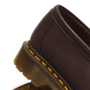 Close-up of a dark brown leather shoe with a thick brown sole and distinctive yellow stitching along the edge, shown on a white background.