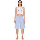 Woman wearing a sleeveless top with eye designs and light blue shorts on a white background