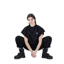 Person wearing a black outfit with a visible brand logo on a white background