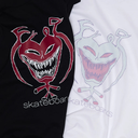 Two short-sleeve graphic T-shirts shown side by side, one black and one white. Each shirt features a large stylized monster face graphic above the word 'skateboard' or 'skateboars' in a thin outlined font.
