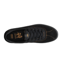 Black sneaker with gold accents on a white background