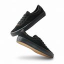 Black sneakers with brown soles on a white background