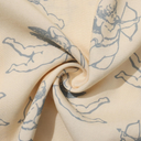Beige fabric with blue angel prints, folded and displayed.