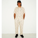 Person wearing a white patterned onesie against a white background