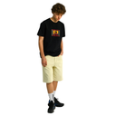 Person wearing a black t-shirt with a colorful logo and light yellow shorts on a white background