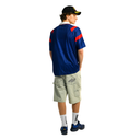 Person wearing a blue sports jersey with red accents on a white background