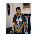 Person wearing a colorful striped shirt with 'LACROSSE' branding in a store setting.