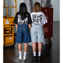 Two people wearing 'Home Boy' t-shirts in a warehouse setting.