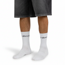 White socks with text worn by a person on a white background