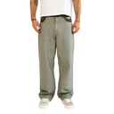 A person wearing loose, wide-leg sage green sweatpants with a white t-shirt and white sneakers, shown from the chest down against a plain white background.
