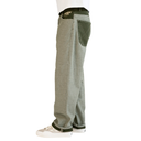 A side profile view of a person wearing relaxed-fit gray heather sweatpants with dark olive green contrast panels on the back pocket and waistband, paired with white sneakers against a plain white background.