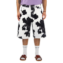 Person wearing white shorts with black cow print and white socks on a white background