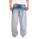 A person shown from the back wearing very baggy light-wash blue jeans with a faded blue wash and a white t-shirt, against a plain white background.