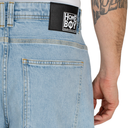 Light blue jeans with a 'Home Boy' patch on the back pocket against a white background