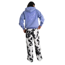 Person wearing a light blue hoodie and black and white patterned pants on a white background
