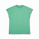 Person wearing a green t-shirt with a small logo on a white background